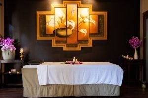 Spacious and comfortable massage bed in a serene spa suite, featuring soft lighting and a tranquil atmosphere for a relaxing spa experience.