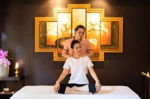 A guest receiving a traditional Thai massage at a spa.