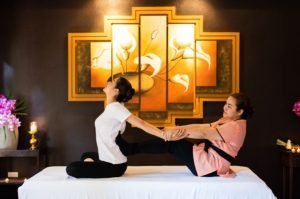 guest receiving a traditional thai massage at a spa in chiang mai, thailand.