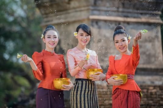 Three Ladies Joyfully Celebrating Songkran Festival In Chiang Mai 2023 By Splashing Water.
